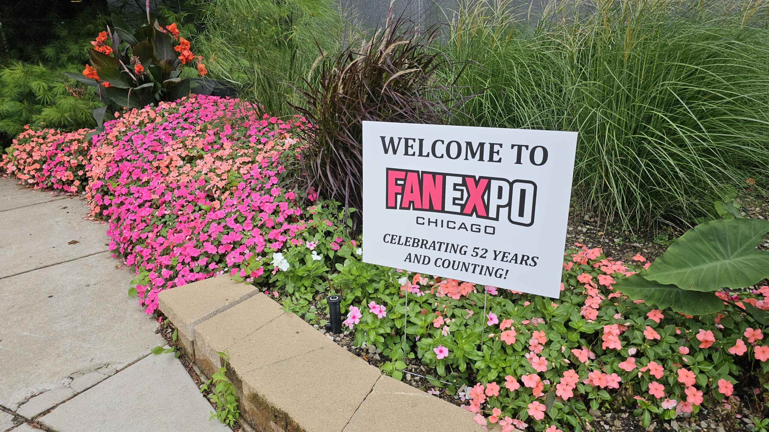 Lawn sign for Fan Expo in flower bed