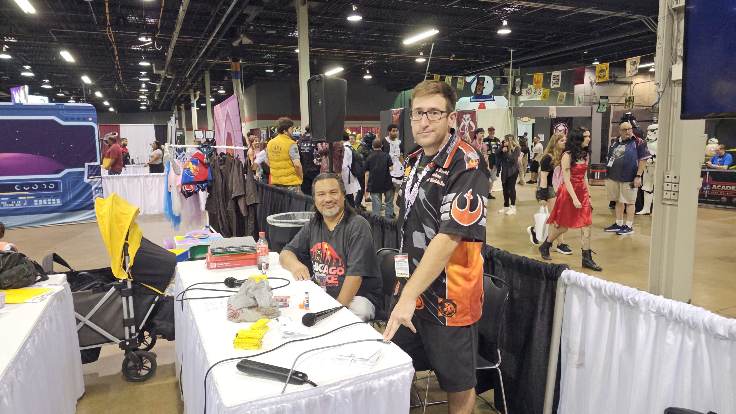 Two men behind a table on show floor