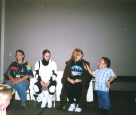 Warwick Davis asking Mary a question